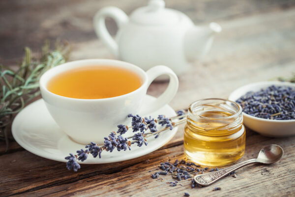 Healthy tea cup, honey, dry lavender flowers and teapot